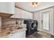 Well-equipped laundry room featuring modern appliances, ample storage, and durable countertops for efficient chores at 301 81St Ne Ave, St Petersburg, FL 33702