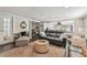 Relaxing living room with plush seating and a view into the kitchen with stainless appliances at 301 81St Ne Ave, St Petersburg, FL 33702