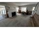 An empty living area showing staircase, fireplace, and natural light, awaiting renovation and customization at 301 81St Ne Ave, St Petersburg, FL 33702