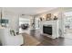 Bright living room featuring a cozy fireplace, hardwood floors, and an inviting seating area at 301 81St Ne Ave, St Petersburg, FL 33702