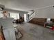 Renovate living area with fireplace and staircase, offering potential for a cozy and stylish home at 301 81St Ne Ave, St Petersburg, FL 33702