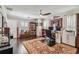 Spacious home office showcasing hardwood floors, ceiling fan, sports memorabilia, and a large desk area at 301 81St Ne Ave, St Petersburg, FL 33702