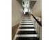 The staircase has black treads and a white handrail at 301 81St Ne Ave, St Petersburg, FL 33702