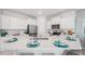 Contemporary kitchen featuring stainless steel appliances, sleek countertops and an eat-in island at 31450 Paper Birch St, Wesley Chapel, FL 33545