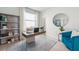 Home office with modern desk, bookshelves, and a comfortable sitting area at 31450 Paper Birch St, Wesley Chapel, FL 33545