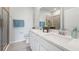 Elegant bathroom featuring double sinks, white countertops, and a glass-enclosed shower at 31458 Paper Birch St, Wesley Chapel, FL 33545