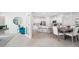 Bright, open-concept living space featuring neutral colors, tile floors, modern furnishings and access to kitchen and dining areas at 31458 Paper Birch St, Wesley Chapel, FL 33545