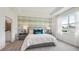 Cozy main bedroom with accent wall, comfortable bed, and en-suite bathroom for ultimate convenience at 31458 Paper Birch St, Wesley Chapel, FL 33545