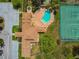 Aerial view of the community pool, hot tub, parking lot, tennis court, and clubhouse at 3520 51St W Ave, Bradenton, FL 34210