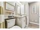 Cozy half bathroom with decorative mirror, sink, toilet, and beach themed decor at 3520 51St W Ave, Bradenton, FL 34210
