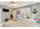 Comfortable bedroom with neutral walls, fan, television, and window with lots of natural light at 3520 51St W Ave, Bradenton, FL 34210