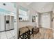 Open entryway into the kitchen, featuring wood floors and decorative elements at 3520 51St W Ave, Bradenton, FL 34210