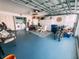 Spacious garage with blue epoxy flooring, laundry area, storage, and organization at 3520 51St W Ave, Bradenton, FL 34210