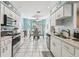 Eat-in kitchen with stainless steel appliances, white cabinets, and breakfast nook at 3520 51St W Ave, Bradenton, FL 34210