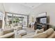 Bright living room with vaulted ceilings and access to an enclosed patio at 3520 51St W Ave, Bradenton, FL 34210