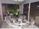 Enclosed patio featuring comfortable wicker seating and lush potted plants, offering a relaxing outdoor space at 3520 51St W Ave, Bradenton, FL 34210