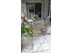 Outdoor patio dining area with wicker furniture, starfish rug, and sliding glass doors leading inside at 3520 51St W Ave, Bradenton, FL 34210