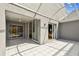 Large tiled patio featuring sliding glass doors to interior rooms and a bright overhead covering at 3520 51St W Ave, Bradenton, FL 34210