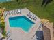 Aerial view of a community pool with clear blue water and plenty of lounge chairs for residents to relax at 3520 51St W Ave, Bradenton, FL 34210