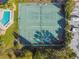 Aerial view featuring tennis courts and a refreshing pool, all set amidst lush greenery and trees at 3520 51St W Ave, Bradenton, FL 34210