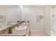 Well-lit bathroom featuring double sinks, granite countertop, and walk-in shower at 35695 Lockman Way, Zephyrhills, FL 33541