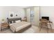 Comfortable bedroom with neutral décor, natural light, and a functional desk area at 35695 Lockman Way, Zephyrhills, FL 33541