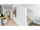 Bright entryway featuring tiled floors, staircase, decor art, and an open view into the dining area at 3629 Copper Beech Dr, Land O Lakes, FL 34638