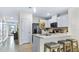 Bright kitchen with stainless steel appliances, white cabinets, and a breakfast bar with stool seating at 3637 Copper Beech Dr, Land O Lakes, FL 34638