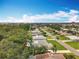 An elevated view of the neighborhood with lush landscaping, homes, and a clear blue sky at 3900 38Th S St, St Petersburg, FL 33711