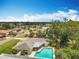 An aerial view of a home, showing the pool, patio, and well-manicured lawn at 3900 38Th S St, St Petersburg, FL 33711
