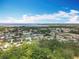 An aerial view showcases a residential community with mature trees and clear blue skies at 3900 38Th S St, St Petersburg, FL 33711