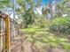 Expansive, grassy backyard surrounded by lush trees and a wooden fence at 3900 38Th S St, St Petersburg, FL 33711