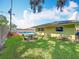 The backyard features a pool, a stone picnic table, and a lush green lawn at 3900 38Th S St, St Petersburg, FL 33711