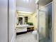 Bright bathroom with a glass-enclosed shower, vanity with sink, and tile flooring at 3900 38Th S St, St Petersburg, FL 33711