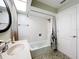 Bright bathroom featuring a combination tub and shower at 3900 38Th S St, St Petersburg, FL 33711