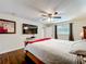 Bedroom showcasing hardwood floors, ceiling fan, and a large mounted TV at 3900 38Th S St, St Petersburg, FL 33711