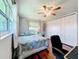 Bedroom featuring hardwood floors, a ceiling fan, and a large closet at 3900 38Th S St, St Petersburg, FL 33711
