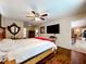 Spacious main bedroom with hardwood floors, a ceiling fan, and large mounted TV at 3900 38Th S St, St Petersburg, FL 33711