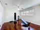 Well-lit home gym features wooden floor and equipment like a total gym and punching bag at 3900 38Th S St, St Petersburg, FL 33711