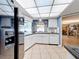 Bright kitchen with modern appliances and a view into the living area and a door to the back of the house at 3900 38Th S St, St Petersburg, FL 33711