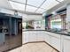 Kitchen featuring modern appliances, tiled floors, and a large window overlooking the pool area at 3900 38Th S St, St Petersburg, FL 33711