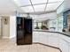 Bright kitchen with modern appliances and a view into the living area and a door to the back of the house at 3900 38Th S St, St Petersburg, FL 33711