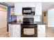 The kitchen features tiled floors, modern appliances, and ample cabinet space for storage at 3900 38Th S St, St Petersburg, FL 33711