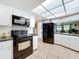 Well-lit kitchen featuring modern appliances, sleek countertops, and a unique, decorative backsplash at 3900 38Th S St, St Petersburg, FL 33711