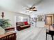 Bright living room with hardwood floors, comfortable seating, and a view into the kitchen and backyard at 3900 38Th S St, St Petersburg, FL 33711