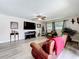 Inviting living room featuring a cozy leather couch, large TV, and stylish decor at 3900 38Th S St, St Petersburg, FL 33711