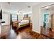 Well-lit main bedroom with hardwood floors, ceiling fan, and ensuite mirrored closet at 3900 38Th S St, St Petersburg, FL 33711