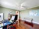 Comfortable office space featuring hardwood floors, a ceiling fan, and a wall-mounted world map at 3900 38Th S St, St Petersburg, FL 33711