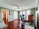 Bright office with wood floors, large windows, an executive chair, and a ceiling fan at 3900 38Th S St, St Petersburg, FL 33711