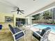 The covered patio boasts ample seating options for relaxing by the pristine pool at 3900 38Th S St, St Petersburg, FL 33711